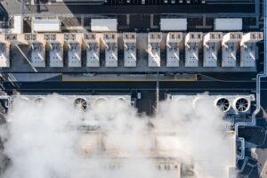 An aerial drone view of a hyperscale data center's large industrial cooling system and fans.