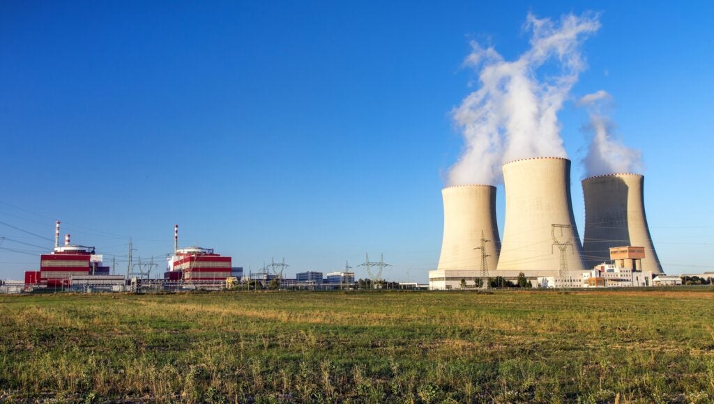 Cooling towers releasing steam clouds at a nuclear power station.