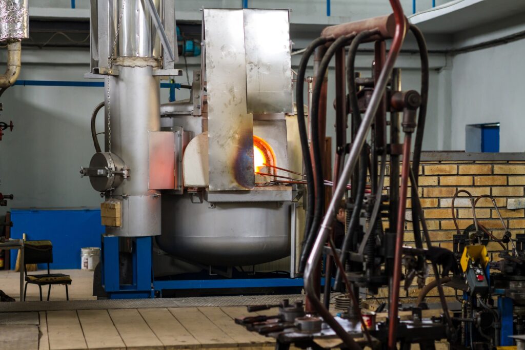 The interior of an industrial furnace used for melting glass at high temperatures.