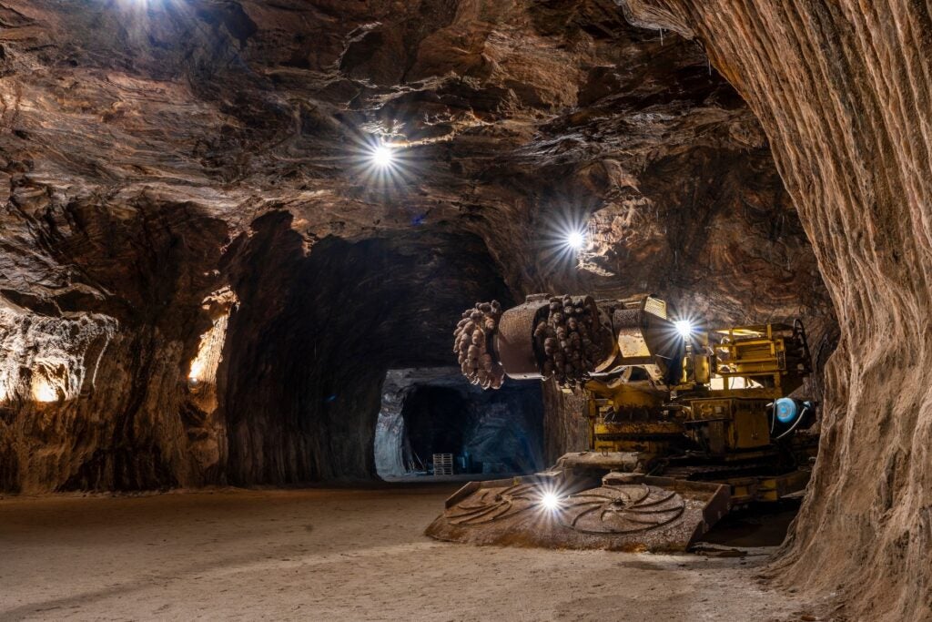 A tunnel boring machine operating inside an underground rock-salt mine tunnel.