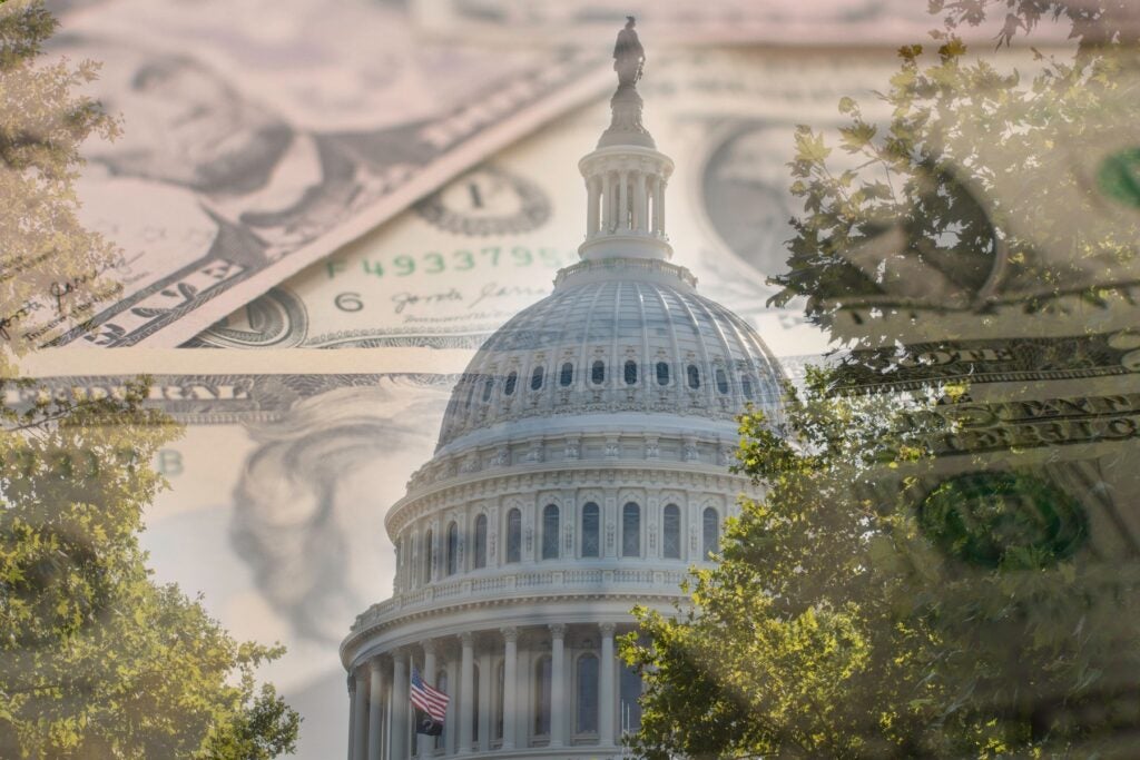 The U.S. Capitol dome framed by trees with an overlay of paper currency, symbolizing federal budget appropriations.